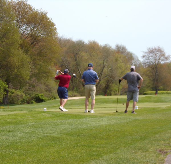 Three golfers on the green