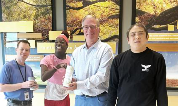 UCP individuals (l to r) Andrew, Falorie & Ting present Charter Oak Federal Credit Union President, Brian Orenstein, a handmade gift as gratitude for their support.